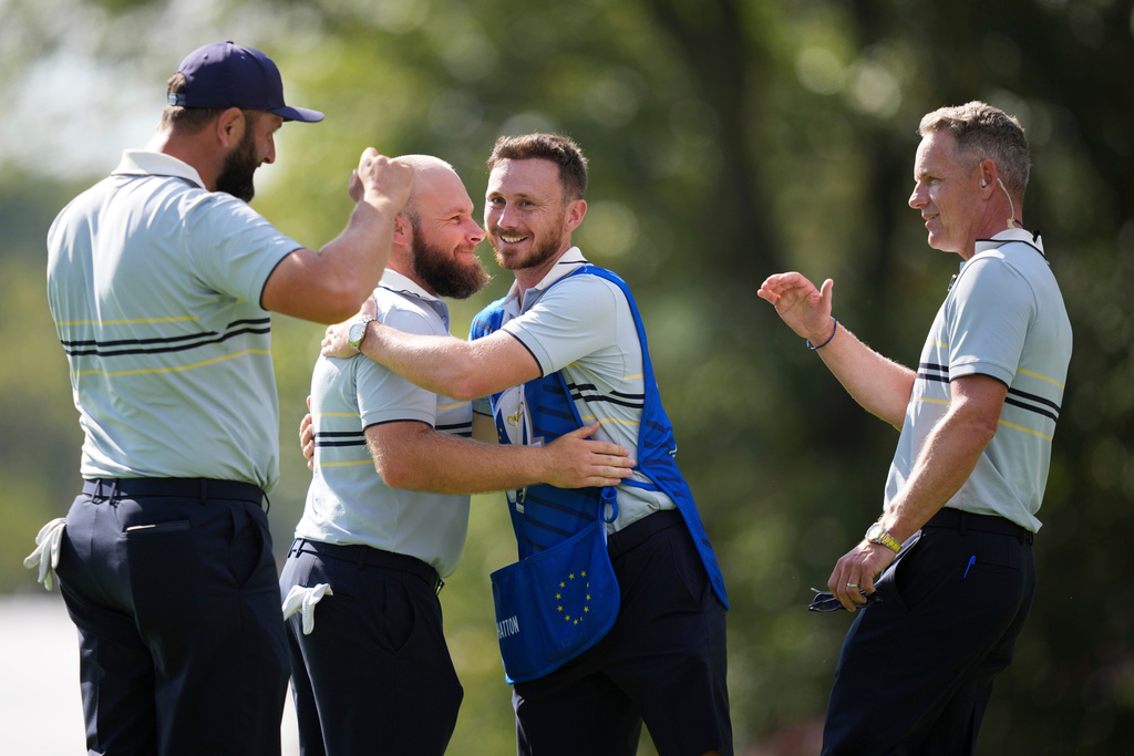 Europe's Jon Rahm, Tyrrell Hatton and captain Luke Donald celebrate after their win on the 15th hole at Bethpage Black golf course during the Ryder Cup golf tournament, Friday, Sept. 26, 2025, in Farmingdale, N.Y. (AP Photo/Matt Slocum)