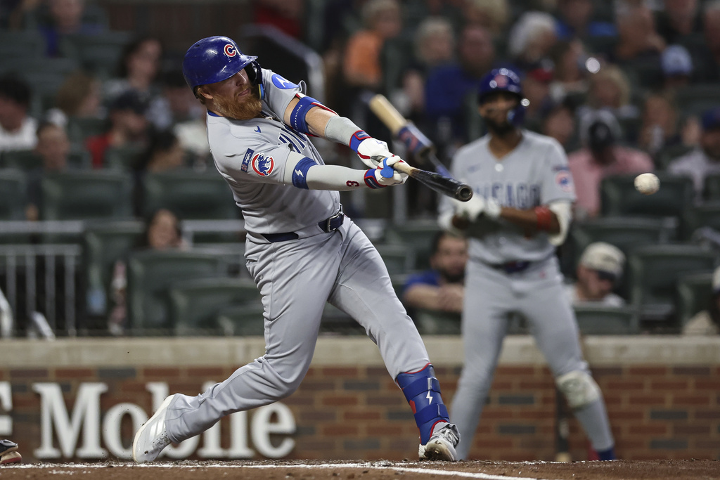 Chicago Cubs' Justin Turner hits an RBI double in the fourth inning of a baseball game against the Atlanta Braves, Wednesday, Sept. 10, 2025, in Atlanta. (AP Photo/Colin Hubbard)