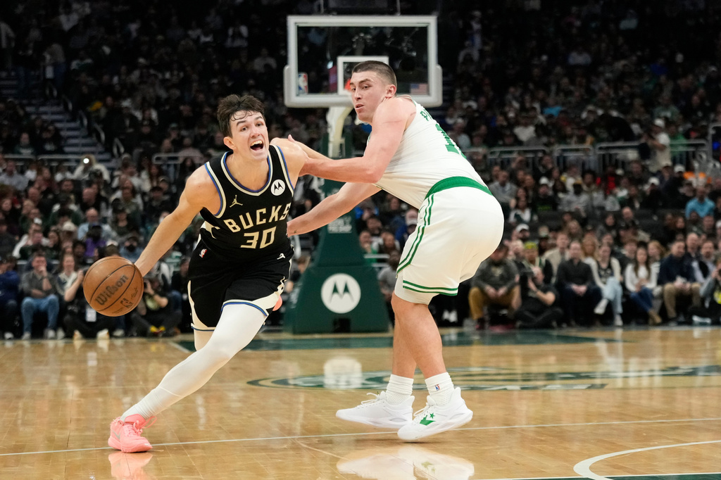 Milwaukee Bucks' Cormac Ryan (30) drives to the basket against Boston Celtics' Payton Pritchard, right, during the first half of an NBA basketball game Friday, April 3, 2026, in Milwaukee. (AP Photo/Aaron Gash)