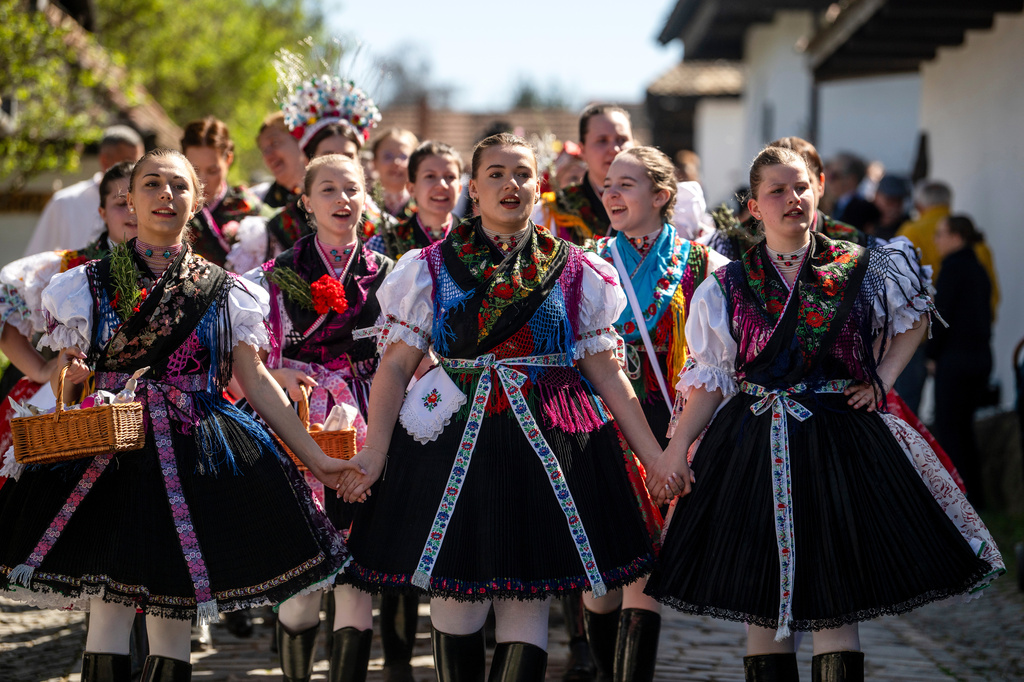 Young women in folk costumes sing during the Easter folk festival in the village of Holloko, a UNESCO World Heritage site, in northeastern Hungary, on Easter Sunday, April 5, 2026. (Peter Komka/MTI via AP)