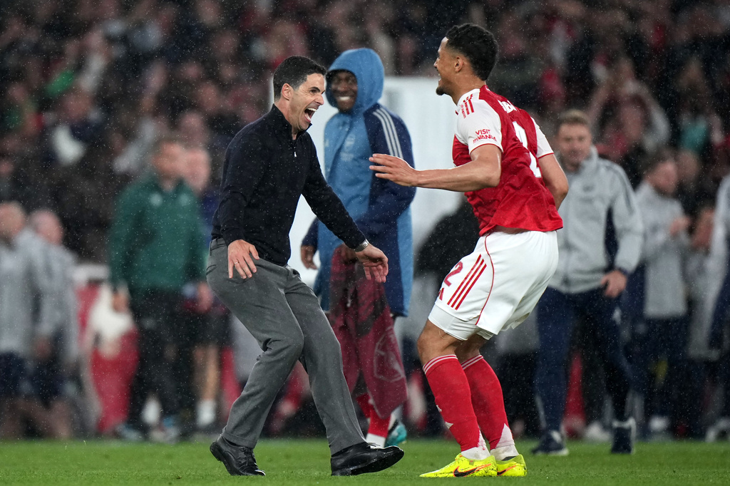 Arsenal's manager Mikel Arteta celebrates with Arsenal's William Saliba at the the end of a Champions League semifinal, second leg, soccer match between Arsenal FC and Atletico Madrid in London, Tuesday, May 5, 2026. (AP Photo/Alastair Grant)