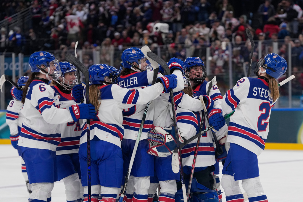 US players celebrate at the end of a preliminary round match of women's ice hockey between USA and Canada at the 2026 Winter Olympics, in Milan, Italy, Tuesday, Feb. 10, 2026. (AP Photo/Petr David Josek)