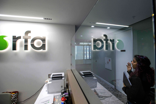 FILE - A woman walks past the empty receptionist desk at Radio Free Asia, April 1, 2025, in Washington. (AP Photo/Rod Lamkey, Jr., File) FILE - A woman walks past the empty receptionist desk at Radio Free Asia, April 1, 2025, in Washington. (AP Photo/Rod Lamkey, Jr., File)