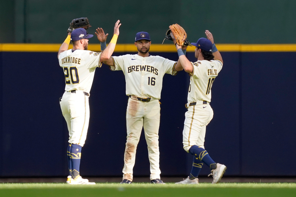 Milwaukee Brewers players, from left, Brandon Lockridge, Blake Perkins and Sal Frelick celebrate defeating the Chicago Cubs 9-3 in Game 1 of baseball's National League Division Series, Saturday, Oct. 4, 2025, in Milwaukee. (AP Photo/Kayla Wolf)