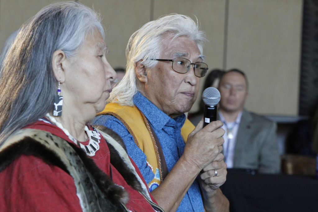 FILE - Fred John Jr., in yellow vest, addresses U.S. Interior Secretary Deb Haaland during the Interior's "Road to Healing" event, Oct. 22, 2023, in Anchorage, Alaska. (AP Photo/Mark Thiessen, File)
