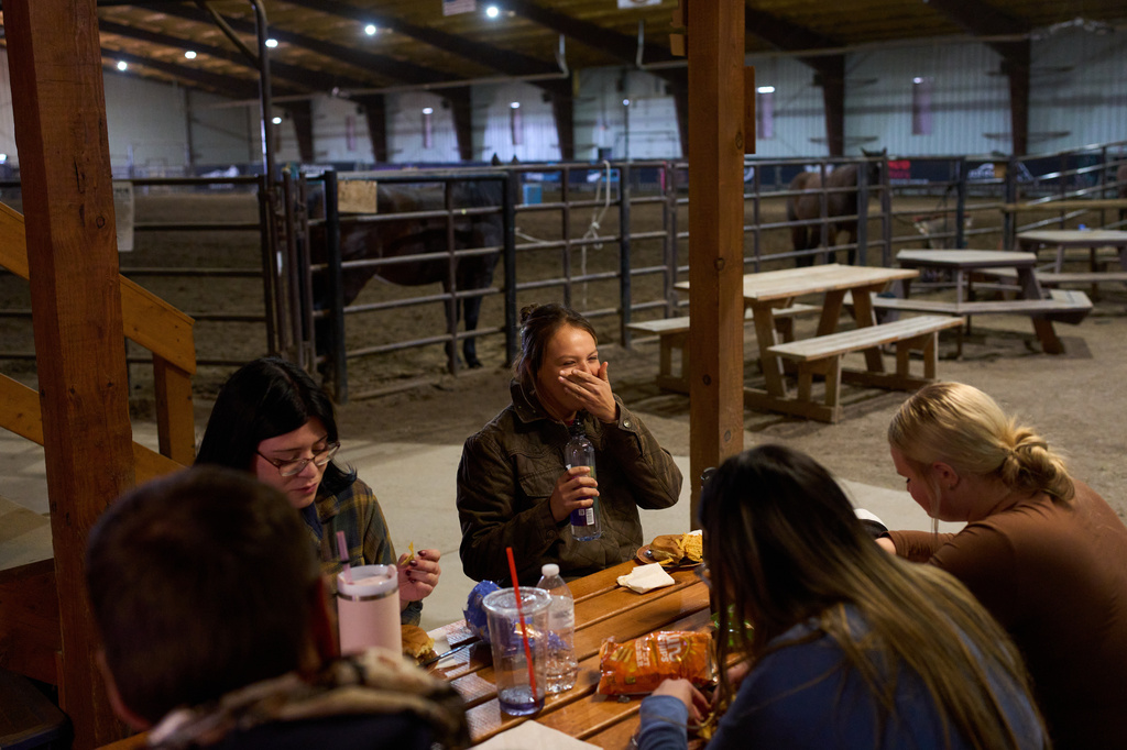 FILE - Jessee Vigen laughs as she eats with fellow students during a class in the Nueta Hidatsa Sahnish College equine studies program at the Healing Horse Ranch, Wednesday, Oct. 29, 2025, in Parshall, N.D. (AP Photo/John Locher, File)
