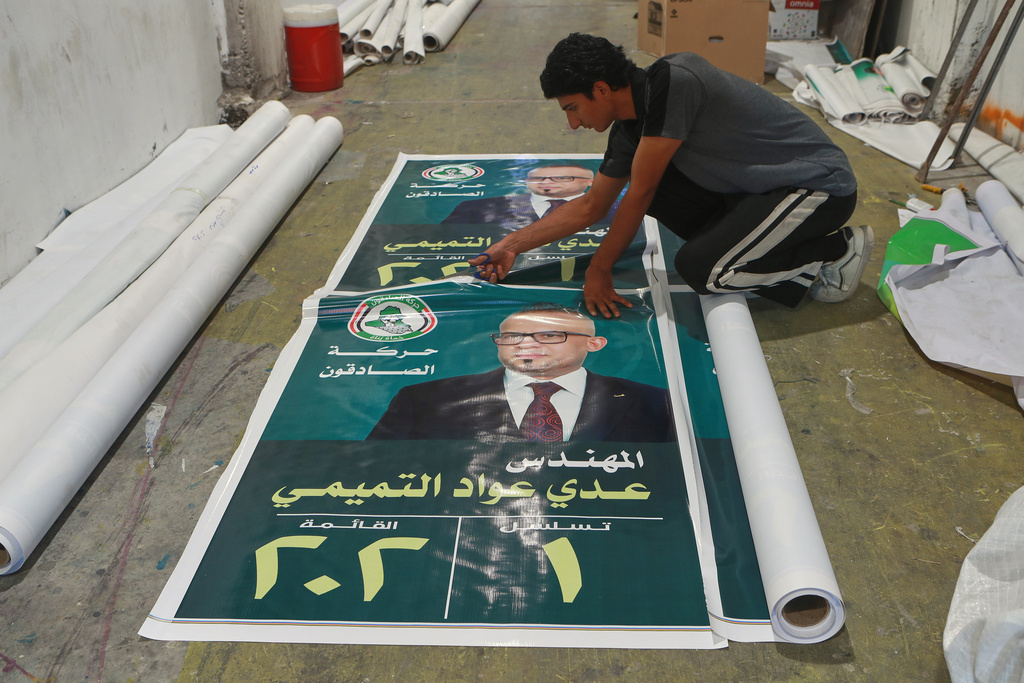 A worker prepares election banners for the Iraqi parliament in Basra, Iraq, Oct. 12, 2025. (AP Photo/Nabil al-Jourani)