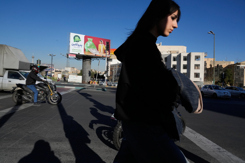A woman crosses a square in Tehran, Iran, Thursday, Feb. 26, 2026. (AP Photo/Vahid Salemi)