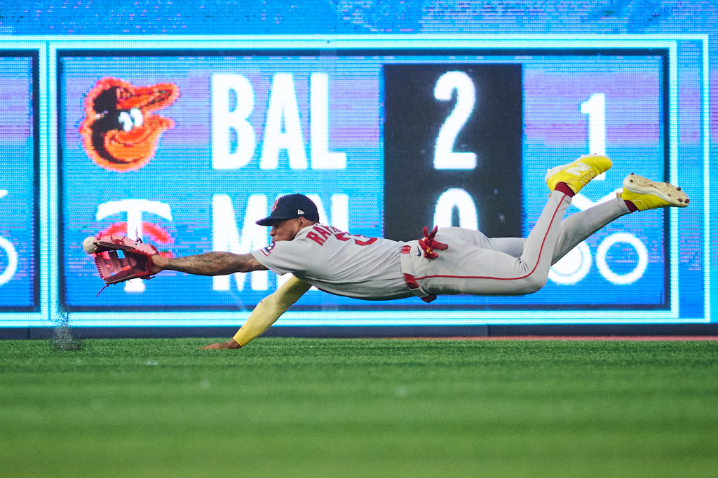 Boston Red Sox's Ceddanne Rafaela (3) can't make the catch as Toronto Blue Jays' Brett Bateman (21) hits an RBI double during third inning MLB baseball action in Toronto, on Tuesday, Aug. 11, 2026. (Sammy Kogan/The Canadian Press via AP)