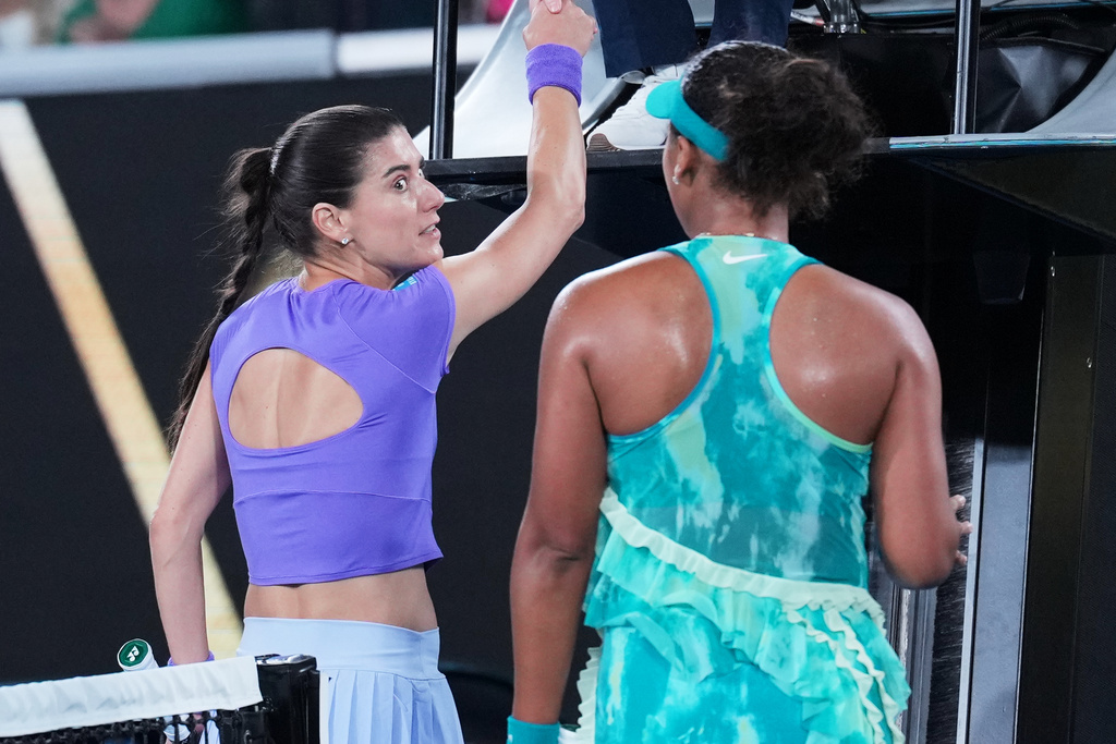 Sorana Cirstea, left, of Romania and Naomi Osaka of Japan talk at the net following their second round match at the Australian Open tennis championship in Melbourne, Australia, Thursday, Jan. 22, 2026. (AP Photo/Dita Alangkara)