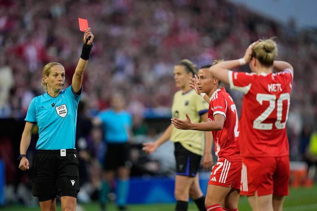Bayern's Franziska Kett, right, gets a red card by referee Ivana Martincic during the Women's Champions League semifinal first leg soccer match between Bayern Munich and Barcelona in Munich, Germany, Saturday, April 25, 2026. (AP Photo/Matthias Schrader)