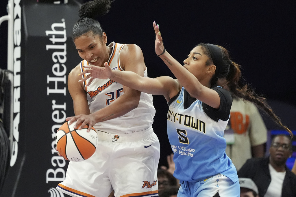 Phoenix Mercury forward Alyssa Thomas, left, grabs a rebound against Chicago Sky forward Angel Reese (5) during the second half of a WNBA basketball game Thursday, Aug. 28, 2025, in Phoenix. (AP Photo/Ross D. Franklin)