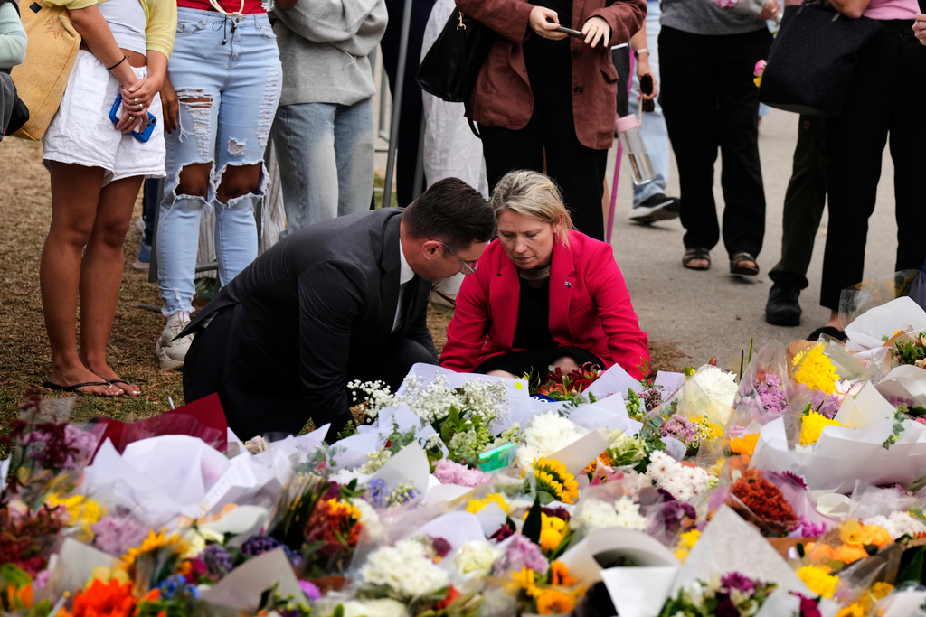 British Consul General Louise Cantillon, lays a wreath at a flower memorial for victims of Sunday's shooting at the Bondi Pavilion at Bondi Beach on Tuesday, Dec. 16, 2025, in Sydney, Australia. (AP Photo/Mark Baker)