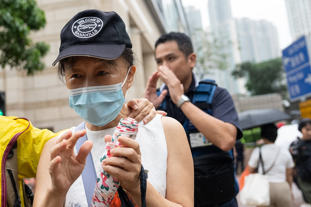 Medina Chow Lau Wah-chun, mother of pro-democracy activist Chow Hang-tung, leaves West Kowloon Magistrates' Courts in Hong Kong, Friday, Aug. 21, 2026. (AP Photo/Chan Long Hei)