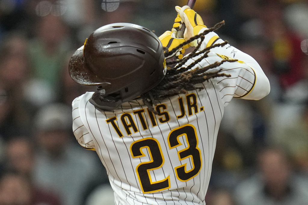 San Diego Padres' Fernando Tatis Jr. swings while batting during the fourth inning of a baseball game against the San Francisco Giants Monday, March 30, 2026, in San Diego. (AP Photo/Gregory Bull)