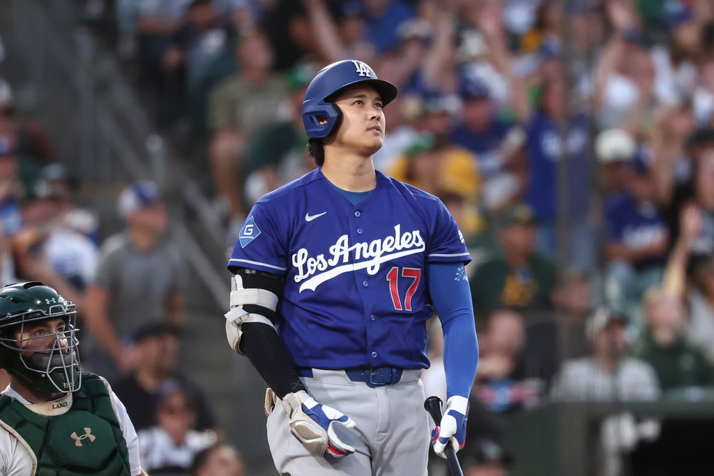 Los Angeles Dodgers' Shohei Ohtani, right, watches his three-run home run during the sixth inning of a baseball game against the Athletics, Monday, June 29, 2026, in West Sacramento, Calif. (AP Photo/Sara Nevis)