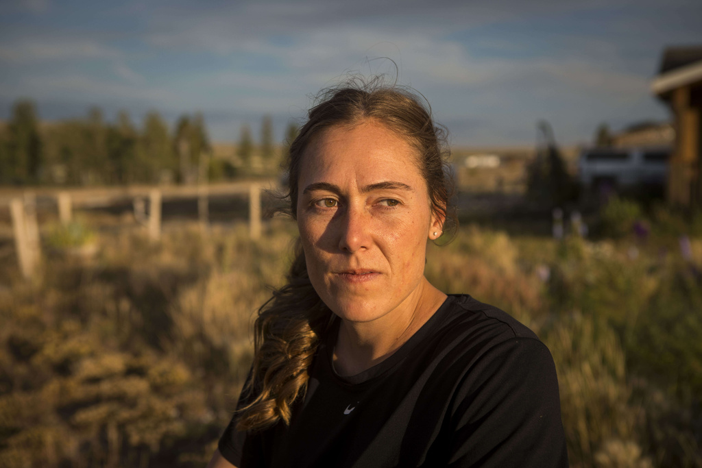 Heather Sterling watches her dog roam the yard at her home, Aug. 11, 2025, near Daniel, Wyo. (AP Photo/Amber Baesler)