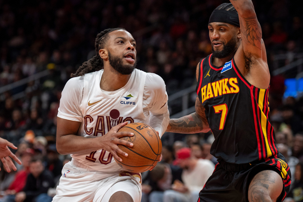 Cleveland Cavaliers guard Darius Garland (10), left, drives the ball down court against Atlanta Hawks guard Nickeil Alexander-Walker (7) during the first half of an NBA Cup basketball game, Friday, Nov. 28, 2025, in Atlanta. (AP Photo/Erik Rank)