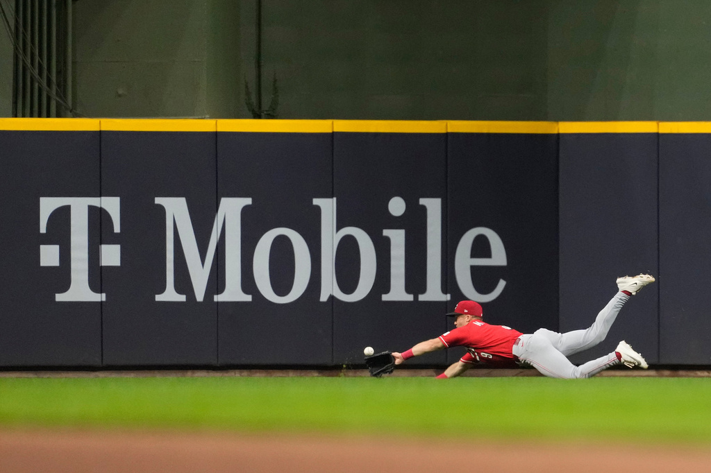 Cincinnati Reds' Matt McLain is unable to make a diving catch on a ball hit by Milwaukee Brewers' Andrew Vaughn during the seventh inning of a baseball game Wednesday, July 1, 2026, in Milwaukee. (AP Photo/Aaron Gash)