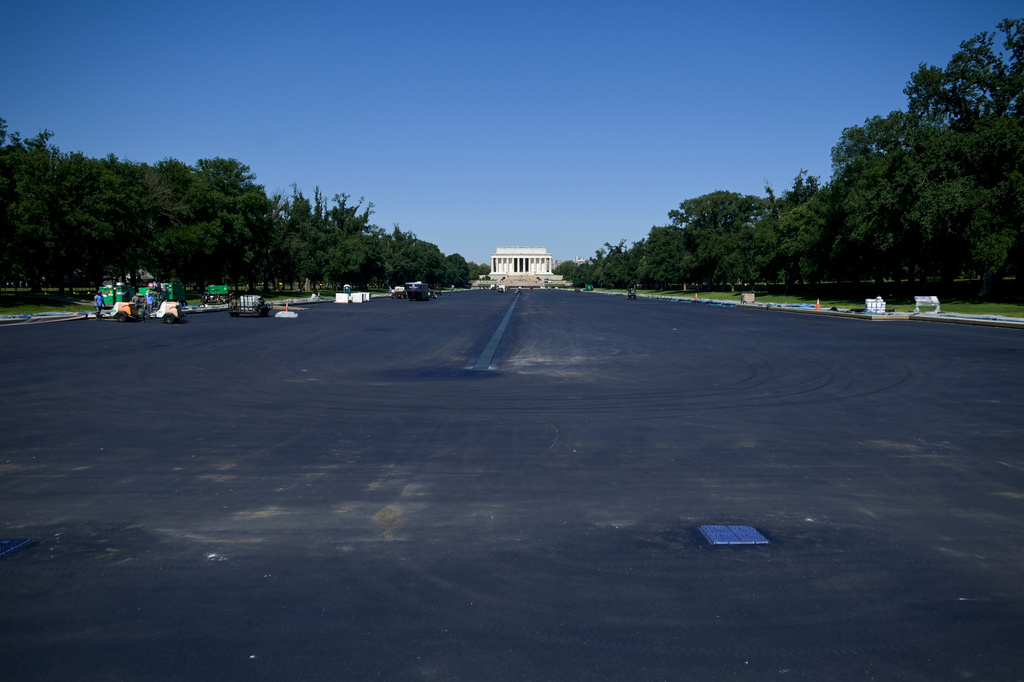 Work continues on the Lincoln Memorial Reflecting Pool, which is covered in a blue protective coating, ahead of the United States 250th anniversary, Thursday, June 4, 2026, in Washington. (AP Photo/Rod Lamkey, Jr.)