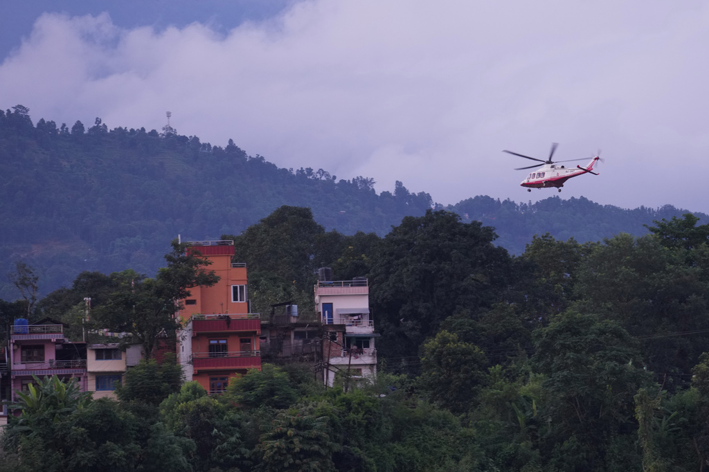 A government helicopter conducts a rescue mission amidst the devastation left by flash flooding in Nepal's Nuwakot district, Thursday, Aug. 27, 2026. (AP Photo/Rajesh Kumar Singh)