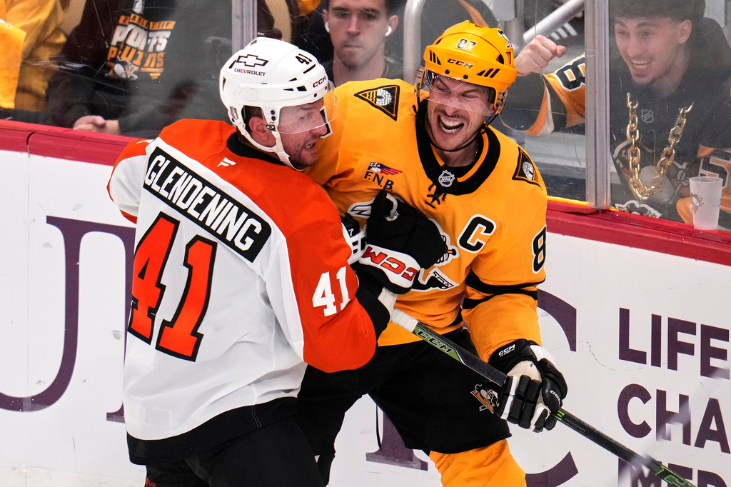 Pittsburgh Penguins' Sidney Crosby, right, is defended by Philadelphia Flyers' Luke Glendening (41) during the third period of Game 5 in the first round of an NHL hockey Stanley Cup playoff series in Pittsburgh, Monday, April 27, 2026. (AP Photo/Gene J. Puskar)