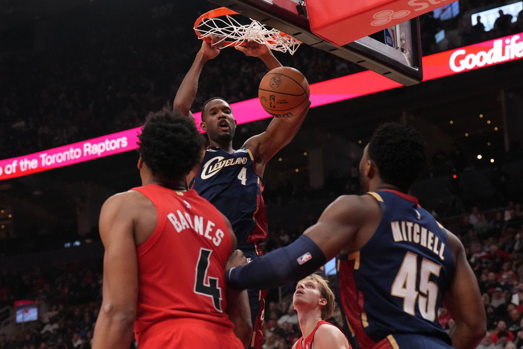 Cleveland Cavaliers center Evan Mobley (4) scores against the Toronto Raptors during the first half of an NBA basketball game in Toronto on Monday Nov. 24, 2025. (Chris Young/The Canadian Press via AP)