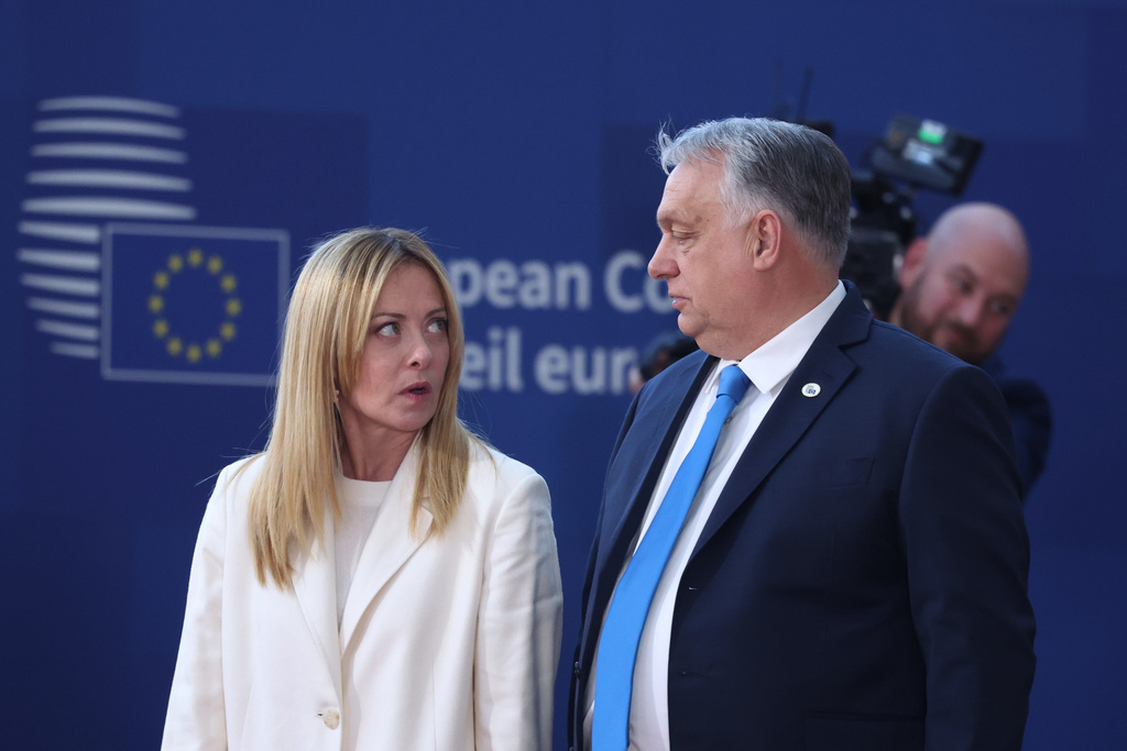 Italy's Prime Minister Giorgia Meloni, left, speaks with Hungary's Prime Minister Viktor Orban prior to a group photo of leaders at the EU summit in Brussels, Thursday, March 19, 2026. (AP Photo/Omar Havana)
