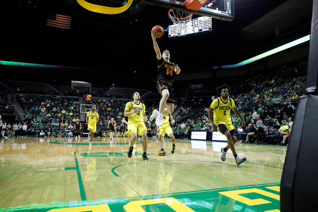 Iowa guard Bennett Stirtz (14) goes up to shoot against Oregon in the second half of an NCAA college basketball game in Eugene, Ore., Sunday, Feb. 1, 2026. (AP Photo/Thomas Boyd)