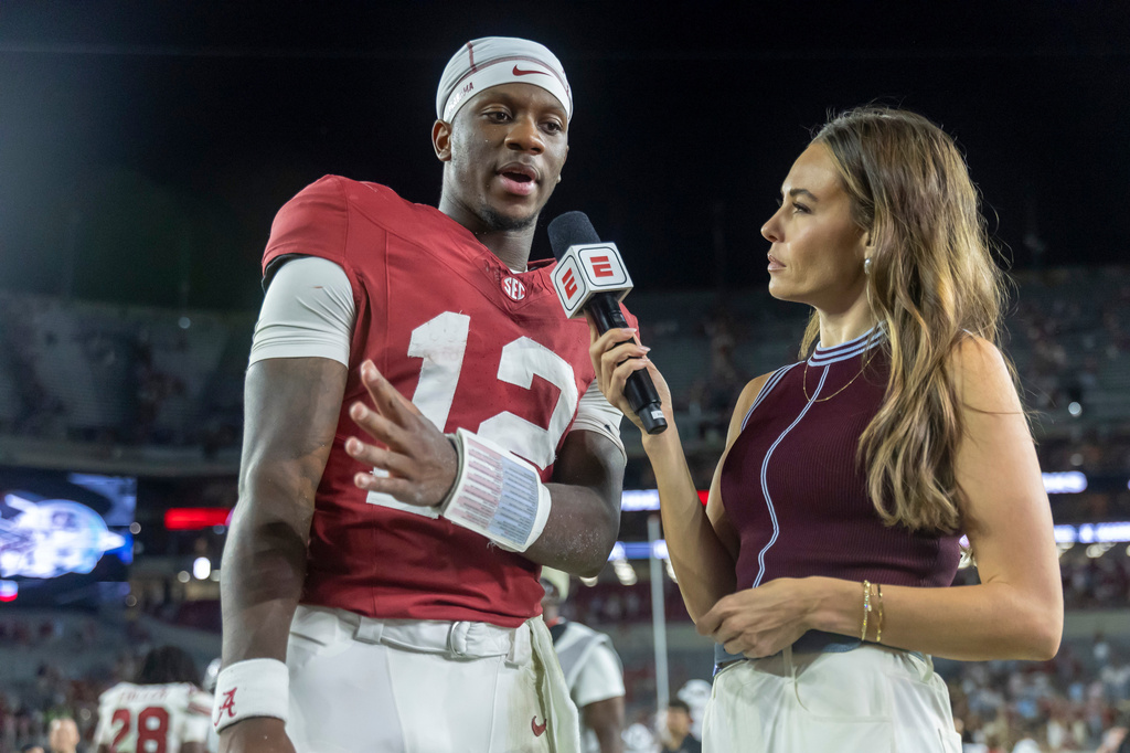 Alabama quarterback Keelon Russell (12) talks with ESPN's Taylor McGregor, right, after an NCAA college football game against South Carolina, Saturday, Sept. 26, 2026, in Tuscaloosa, Ala. (AP Photo/Vasha Hunt)