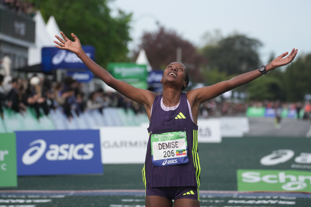 Ethiopia's Shure Demise crosses the finish line to win the women's race of the Paris marathon, in Paris, Sunday, April 12, 2026. (AP Photo/Thibault Camus)
