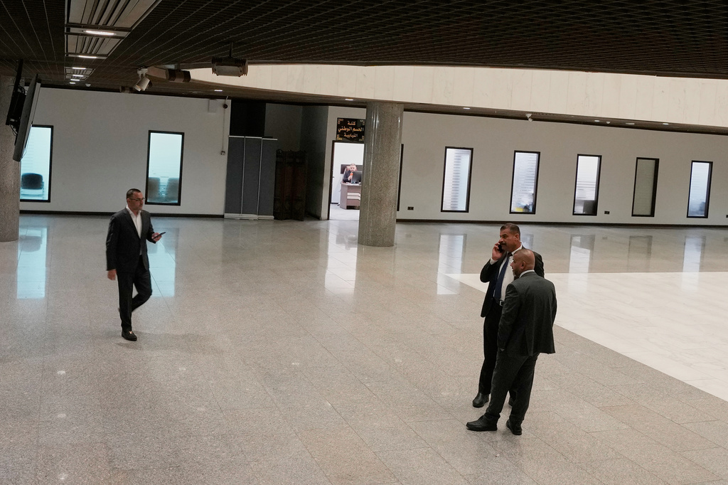 Members of the Iraqi parliament appear before entering the parliament hall to elect the President of the Republic in Baghdad, Iraq, Saturday, April 11, 2026. (AP Photo/Hadi Mizban)