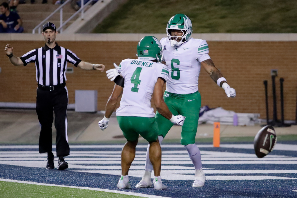 North Texas wide receiver Cameron Dorner (4) and tight end Tre Williams III (6) celebrate a touchdown by Williams against Rice during the first half of an NCAA college football game, Saturday, Nov. 22, 2025, in Houston. (AP Photo/Michael Wyke)