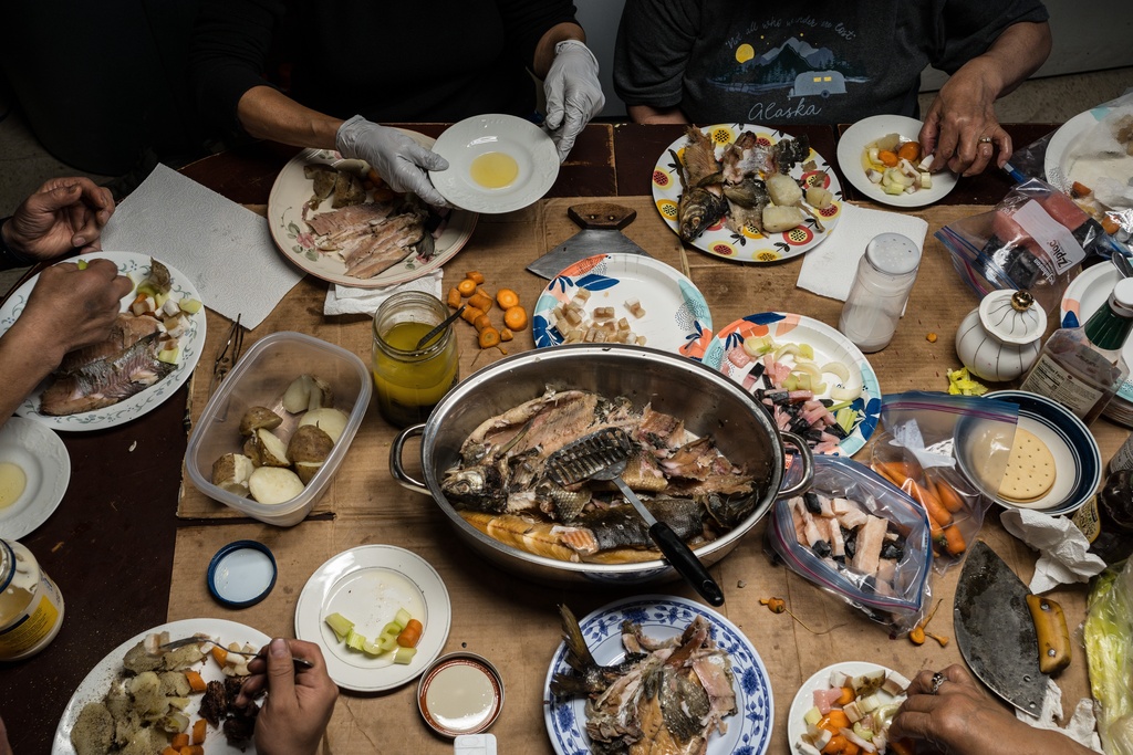 Tristen Pattee and his family eat a meal of beluga whale, bowhead whale, whitefish, moose and seal in Ambler, Alaska, Wednesday, Oct. 2, 2025. (AP Photo/Annika Hammerschlag)