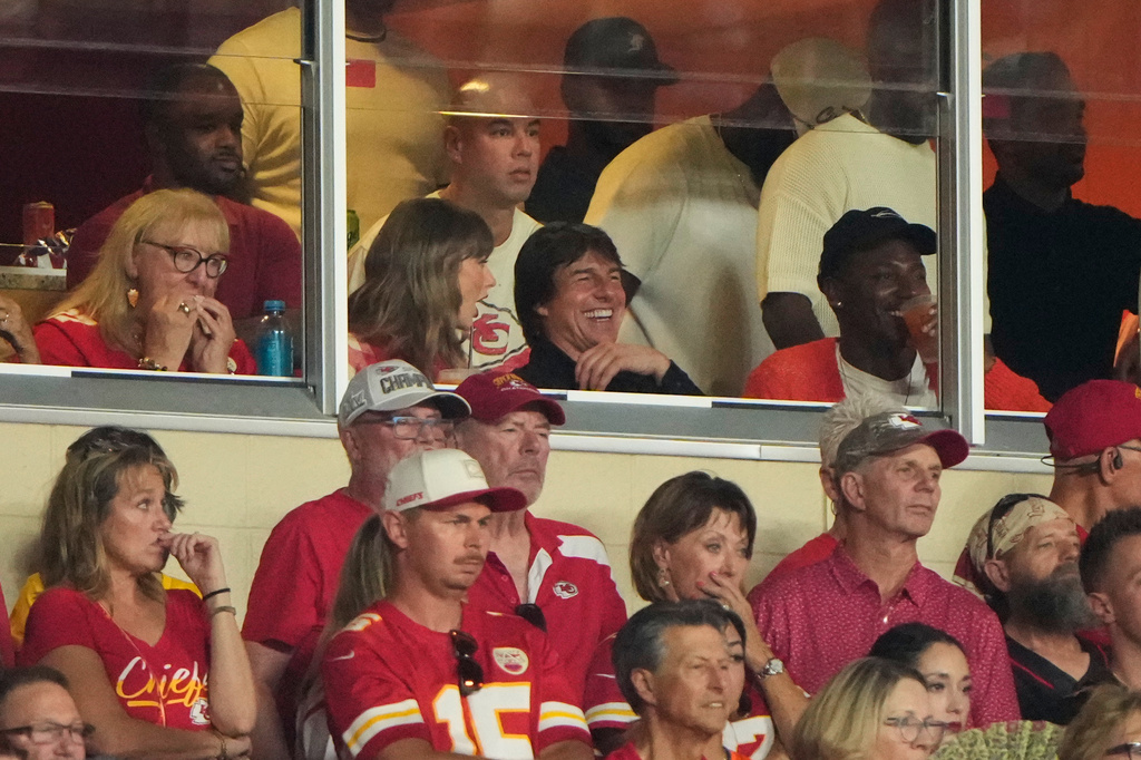 Taylor Swift, left, sits with Tom Cruise, center, while watching the first half of an NFL football game between the Kansas City Chiefs and the Denver Broncos, Monday, Sept. 14, 2026, in Kansas City, Mo. (AP Photo/Charlie Riedel)