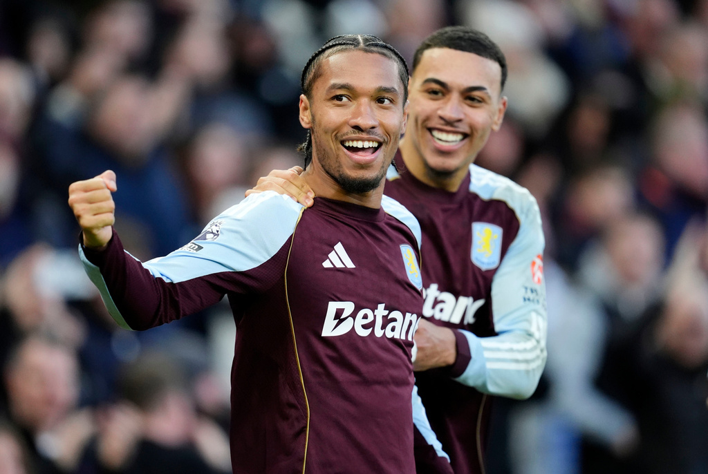 Aston Villa's Boubacar Kamara, foreground, celebrates with Aston Villa's Morgan Rogers after scoring his side's first goal, during the English Premier League soccer match between Aston Villa and Wolverhampton Wanderers, at Villa Park, in Birmingham, England, Sunday, Nov. 30, 2025. (Nick Potts/PA via AP)
