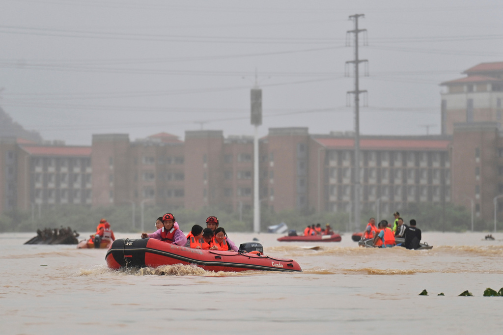 In this photo released by Xinhua News Agency, rescuers evacuate stranded teachers and students at Xijiang education park in the aftermath of tropical storm Maysak in Guigang City, south China's Guangxi Zhuang Autonomous Region, July 8, 2026. (Zhou Hua/Xinhua via AP)