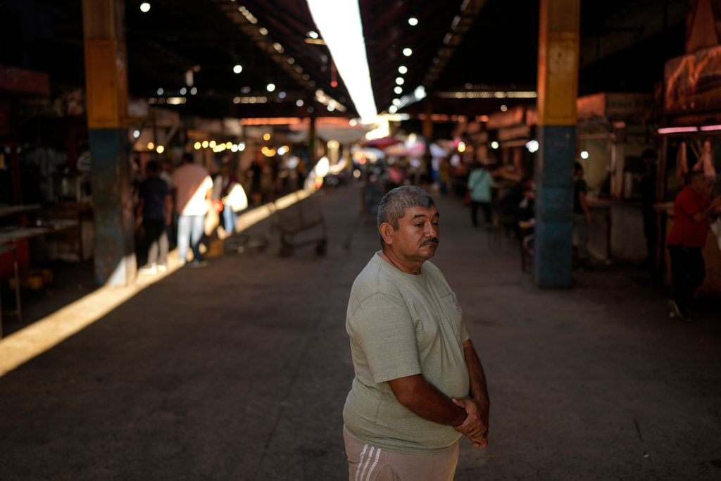 Butcher Richard Lazcano waits to load meat he purchased at Las Pulgas market onto a bus to take to the Colombian border to sell, in Maracaibo, Venezuela, June 19, 2025. Lazcano returned to his old job after his attempt to reach the United States was cut short when the Trump administration suspended asylum appointments. (AP Photo/Matias Delacroix)