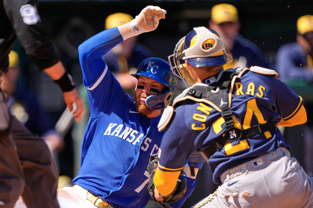 Kansas City Royals' Bobby Witt Jr. (7) is tagged out by Milwaukee Brewers catcher William Contreras as he tried to score on a single by Vinnie Pasquantino during the third inning of a baseball game Sunday, April 5, 2026, in Kansas City, Mo. (AP Photo/Charlie Riedel)