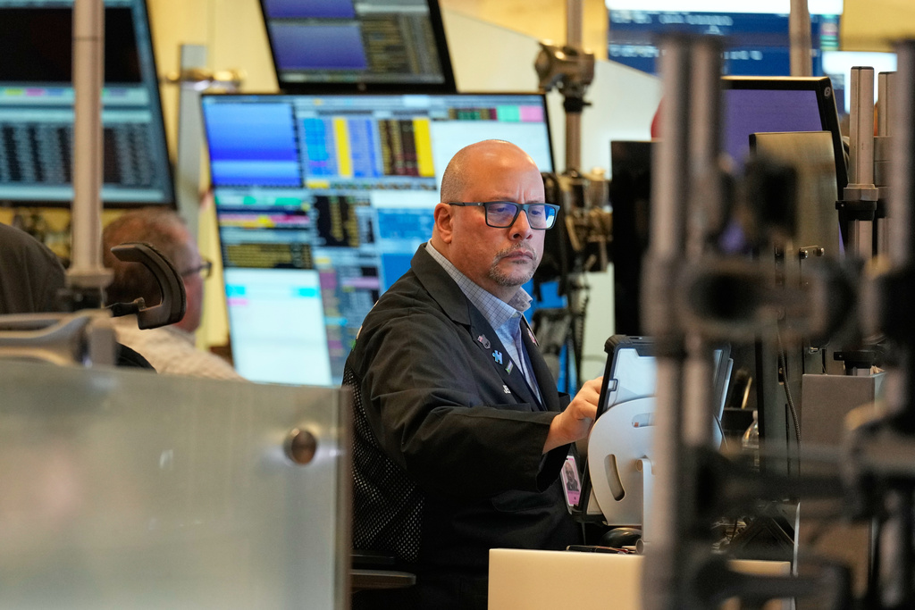Jeff Vazquez works on the floor at the New York Stock Exchange in New York, Tuesday, Nov. 11, 2025. (AP Photo/Seth Wenig)