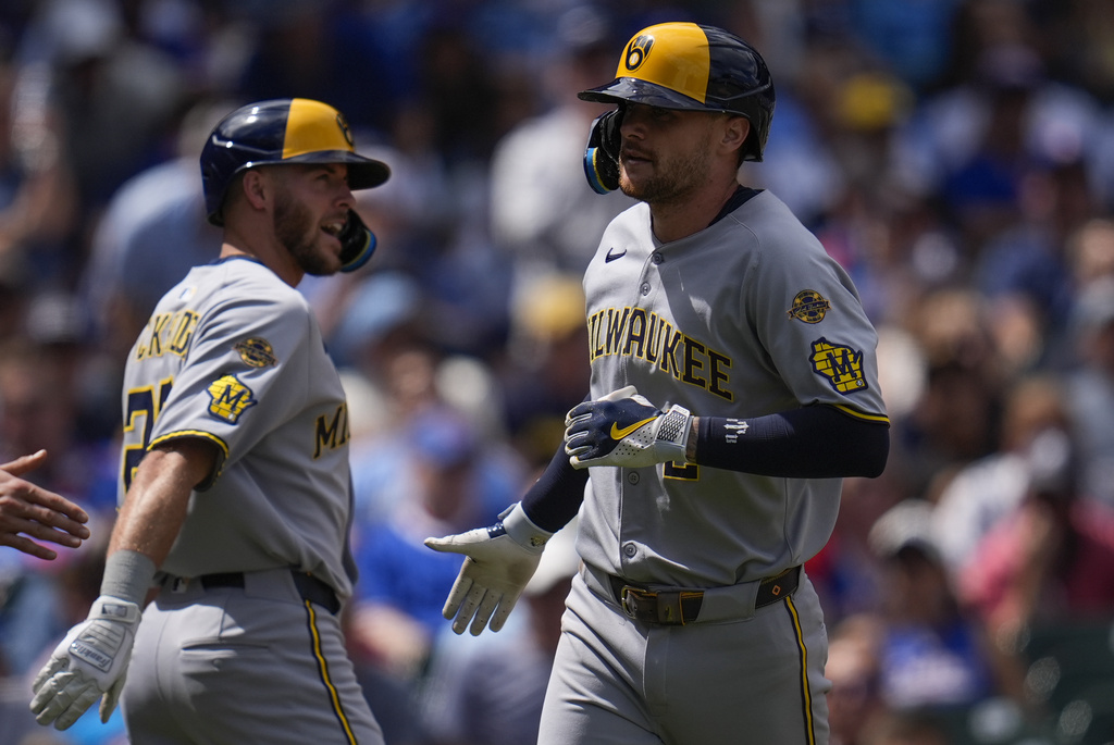 Milwaukee Brewers' Brice Turang (2), right, celebrates after hitting a two-run home run during the second inning of a baseball game against the Chicago Cubs, Thursday, Aug. 21, 2025, in Chicago. (AP Photo/Erin Hooley)