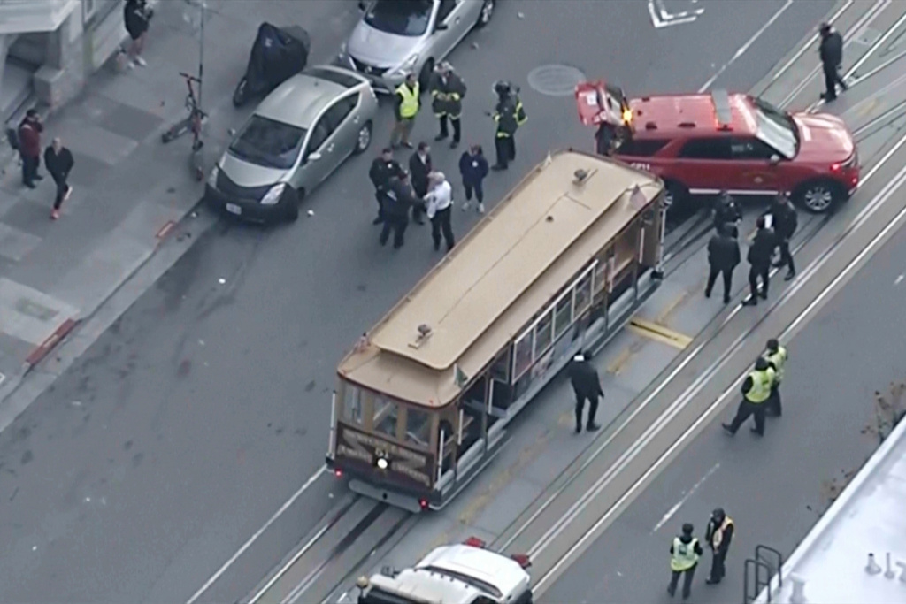 This image taken from video provided by KGO-TV shows law enforcement responding to a cable car's abrupt stop on California Street, Monday, Dec. 15, 2025, in San Francisco. (KGO-TV via AP)