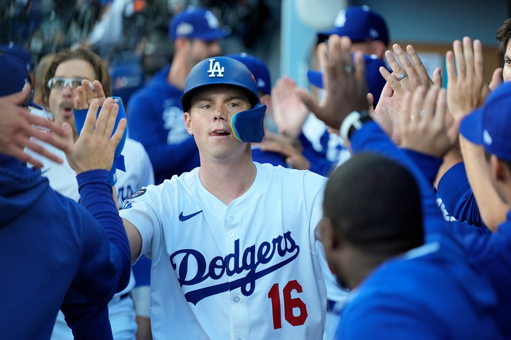 Los Angeles Dodgers' Will Smith celebrates in the dugout after scoring against the Milwaukee Brewers during the seventh inning in Game 3 of baseball's National League Championship Series, Thursday, Oct. 16, 2025, in Los Angeles. (AP Photo/Ashley Landis)