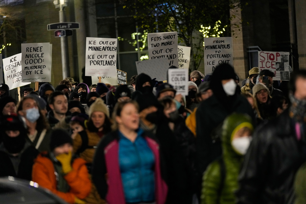 People march to the U.S. Immigration and Customs Enforcement facility in honor of victims of ICE shootings Friday, Jan. 9, 2026, in Portland, Ore. (AP Photo/Jenny Kane)