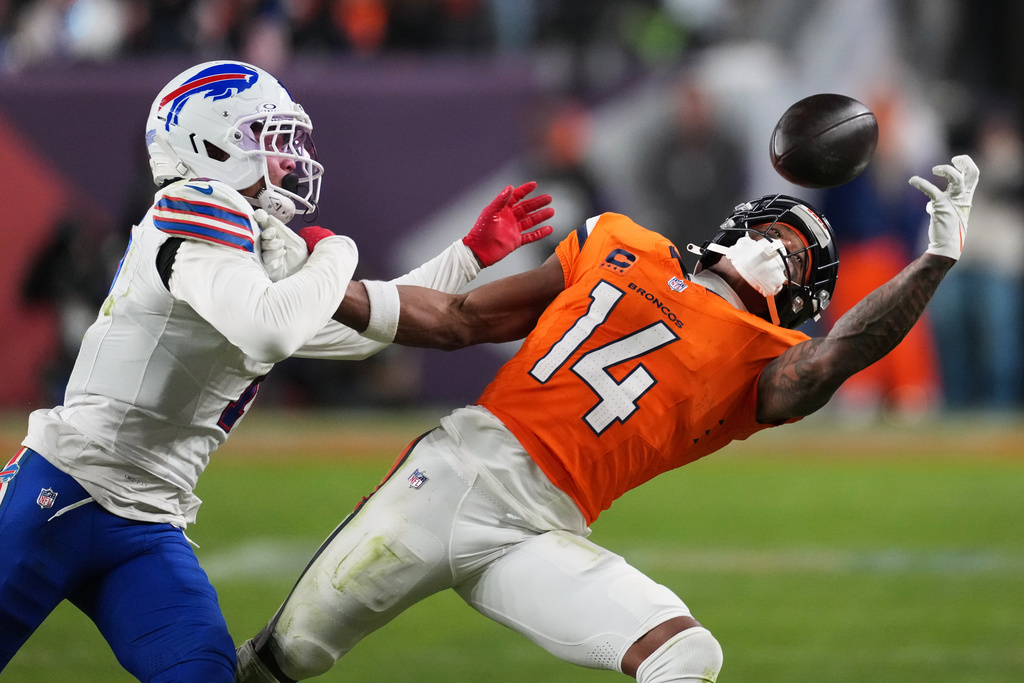 Buffalo Bills cornerback Taron Johnson (7) is called for pass interference against Denver Broncos wide receiver Courtland Sutton (14) during overtime of an NFL divisional round playoff football game, Wednesday, Jan. 17, 2024, in Denver. (AP Photo/David Zalubowski)