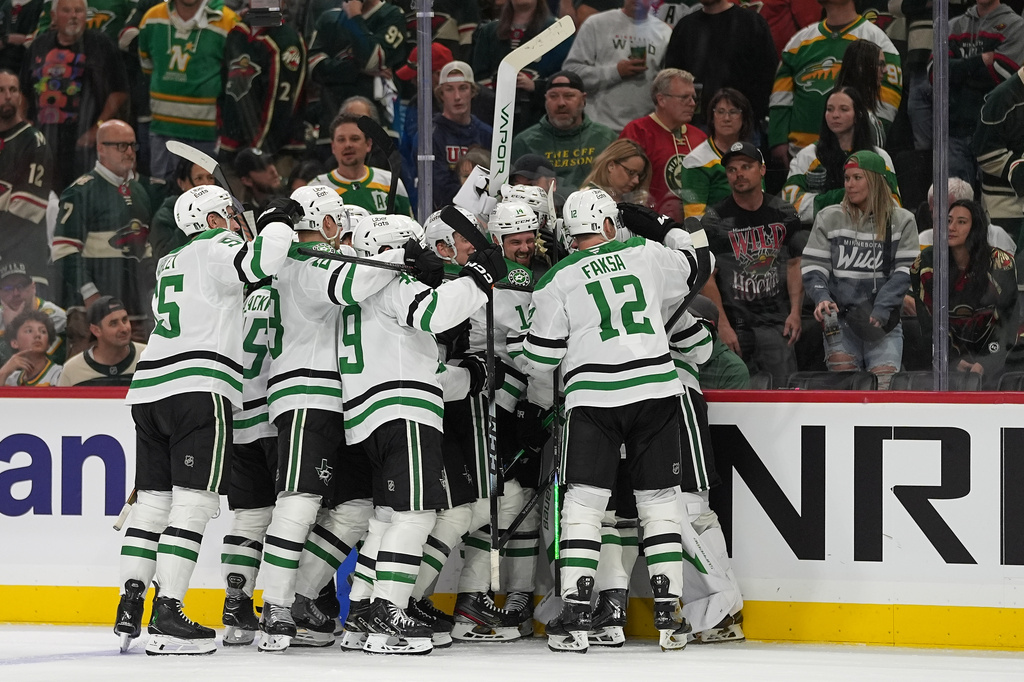 Dallas Stars players celebrate after the double overtime win against the Minnesota Wild of Game 3 in the first round of the NHL Stanley Cup hockey playoffs early morning Thursday, April 23, 2026, in St. Paul, Minn. (AP Photo/Abbie Parr)