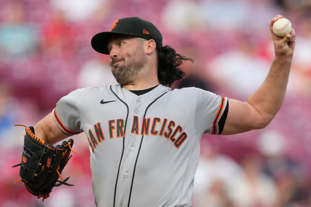 San Francisco Giants pitcher Robbie Ray throws during the first inning of a baseball game against the Cincinnati Reds in Cincinnati, Tuesday, April 14, 2026. (AP Photo/Carolyn Kaster)