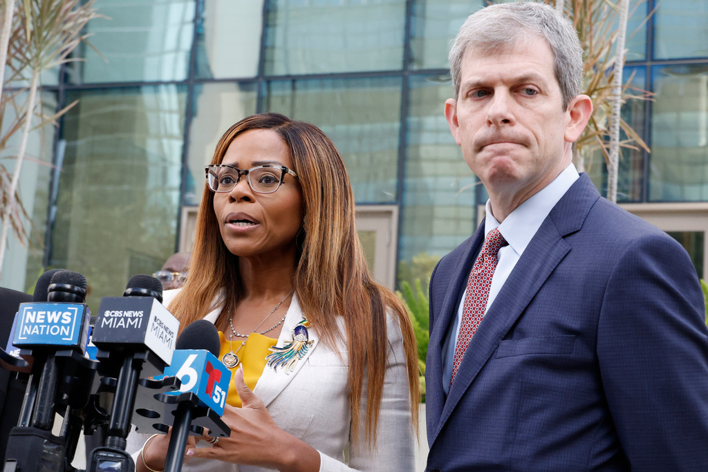 CORRECTS TO HEARING, NOT ARRAIGNMENT - U.S. Rep. Sheila Cherfilus-McCormick, D-Fla., left, speaks to the media as her lawyer David Markus looks on after a hearing in federal court Monday, Dec. 29, 2025 in Miami. (AP Photo/Terry Renna)