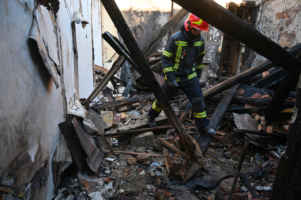 A rescue worker walks inside apartments destroyed by a Russian strike in Odesa, Ukraine, Monday, April 27, 2026. (AP Photo/Michael Shtekel)
