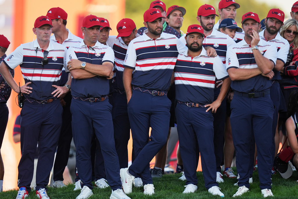 Members of the United States team watch after losing Ryder Cup golf tournament on the Bethpage Black golf course, Sunday, Sept. 28, 2025, in Farmingdale, N.Y. (AP Photo/Seth Wenig)